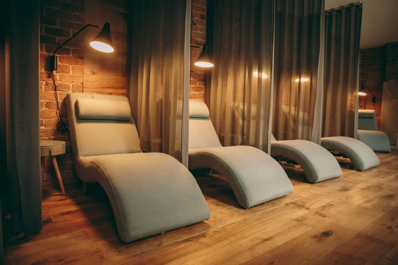 a row of beds in a room with mirrors at Hope Street Hotel in Liverpool
